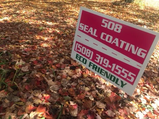 A yard sign for 508 Sealcoating on a lawn, highlighting our eco-friendly products and commitment to the environment in Boxborough.